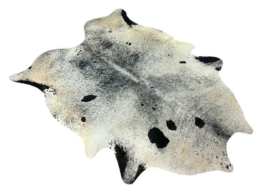 White cowhide with black patches and black speckled spots