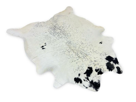 White cowhide with black patches on neck and black speckled spots on sides