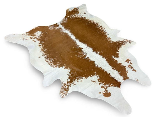 Light brown cowhide with white spine and ends and speckled brown sides