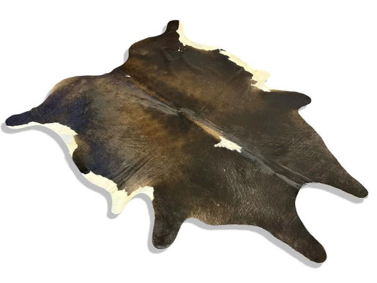 Tri color cowhide with white edges and light brown shade on centre and back