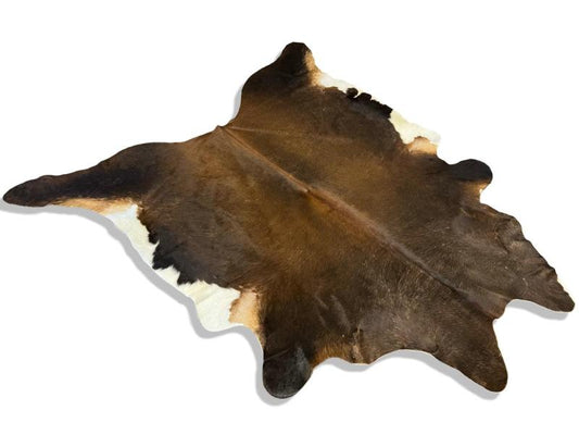 Tri color cowhide with a mix of black and dark brown with white under legs